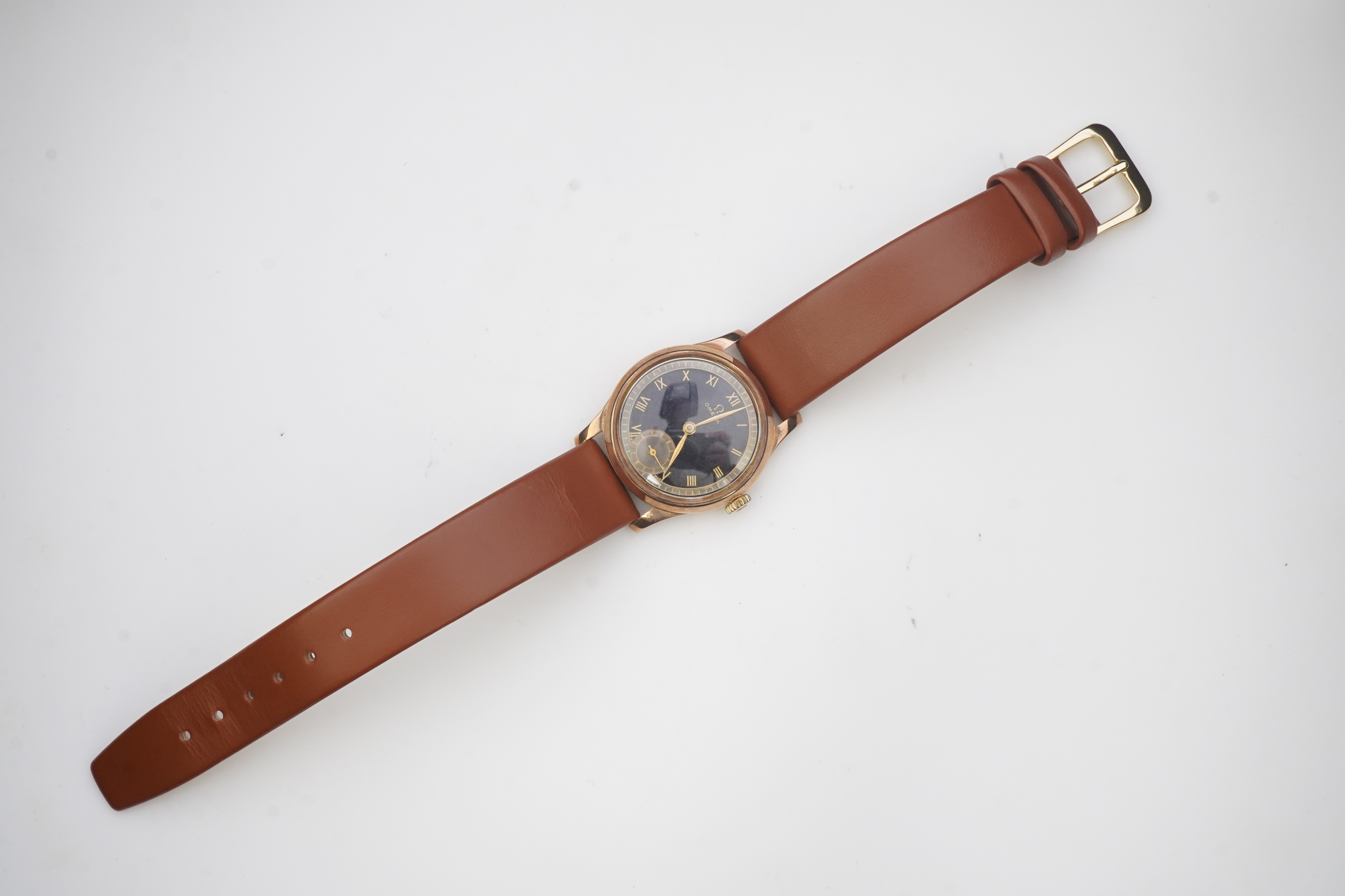 A gentleman's 1940's 9ct gold Omega manual wind wrist watch, on a later associated leather strap